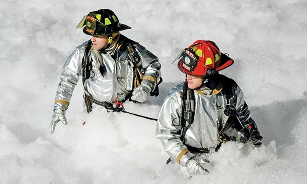 Firefighters waist-deep in PFAS-containing foam