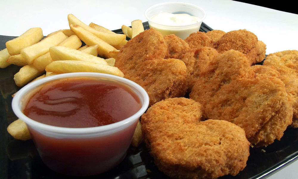 Heart-shaped chicken nuggets on a tray of fast food