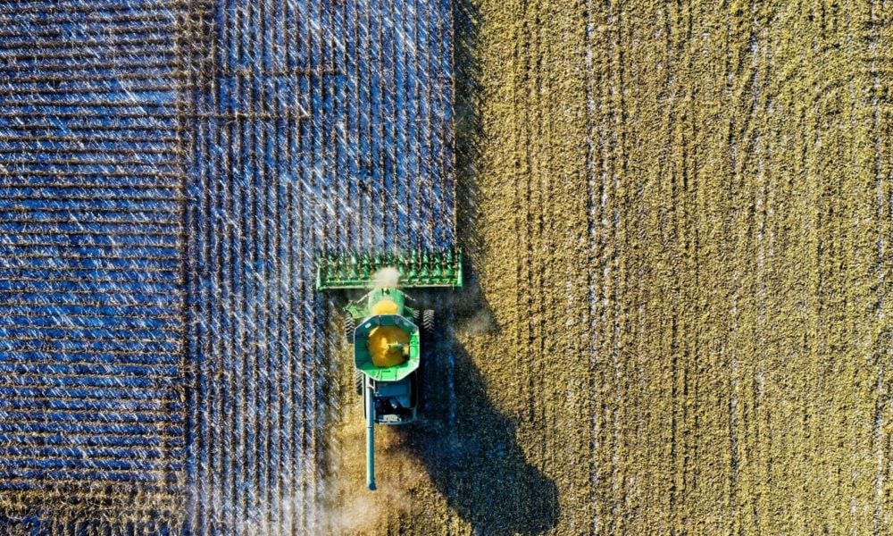 Aerial shot of a green milling tractor in a field in Austin, TX