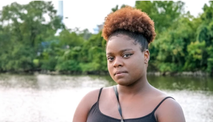 Co-author Shashawnda Campbell poses in front of a body of water