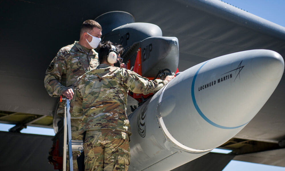 airmen secure rapid response weapon under plane wing