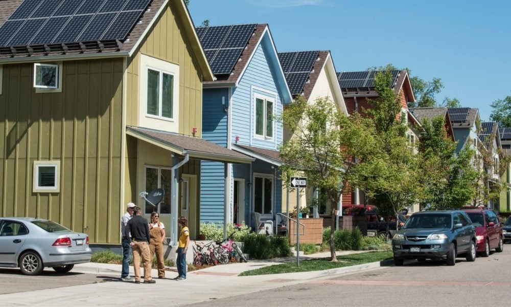 A neighborhood of Boulder, CO, featuring colorful homes with solar paneled roofs
