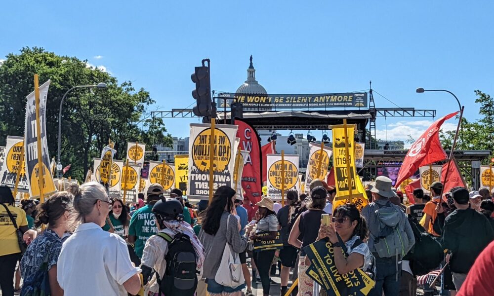 A photo taken of marchers at the Poor People's Campaign Assembly and Moral March in June, in Washington, D.C. A banner reads "We won't be silent anymore"