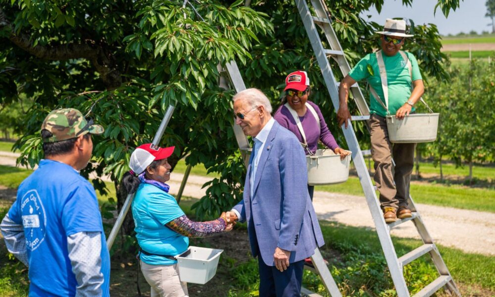 President Joe Biden greets farm workers in Central Lake, Michigan.