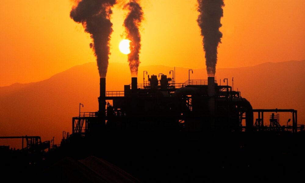 Refinery Smokestacks at sunset