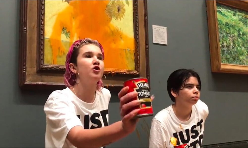 Phoebe Plummer and Anna Holland from Just Stop Oil addressing the public after throwing tomato soup on Vincent van Gogh’s Vase with Fifteen Sunflowers (1888).