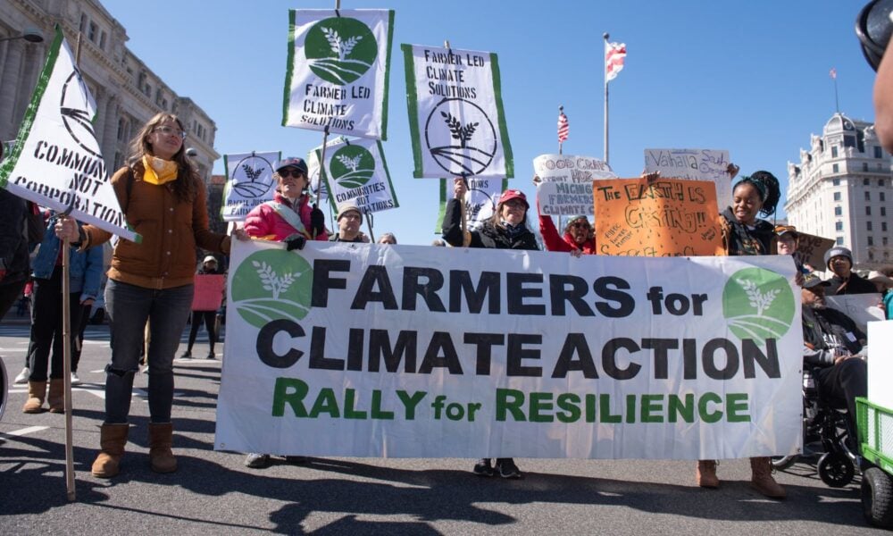 a group of people at a D.C. rally holding a banner that reads, "Farmers for Climate Action: rally for resilience"