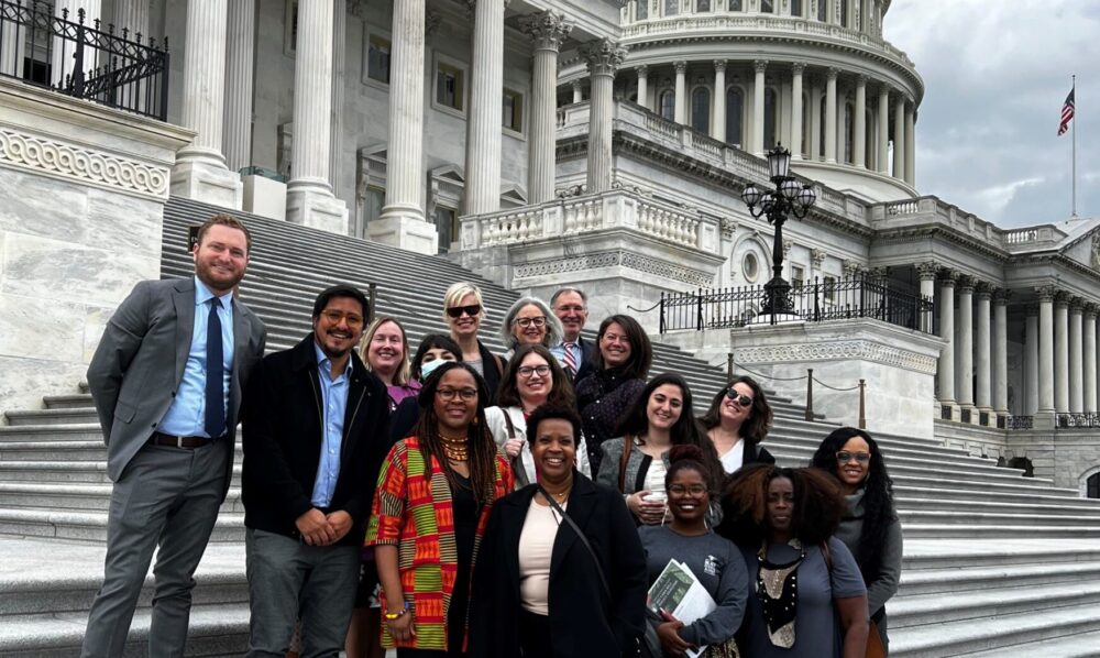 photo of members of the Good Food For All coalition posing on the steps in front of the US Capitol in May 2023
