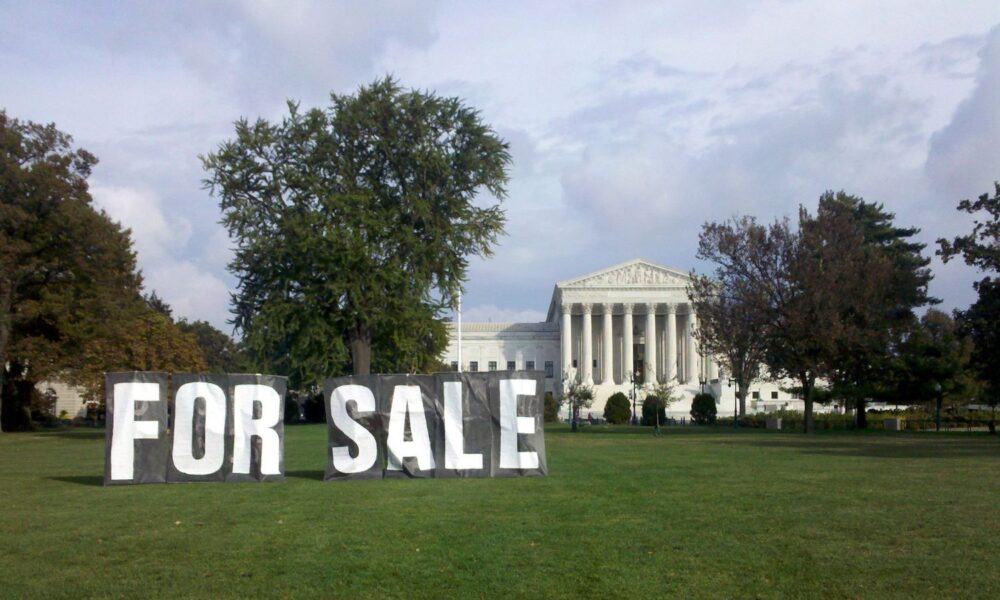 A large "FOR SALE" sign looms on the lawn in front of the US Supreme Court, in a photo taken in 2010 as a protest against Citizens United
