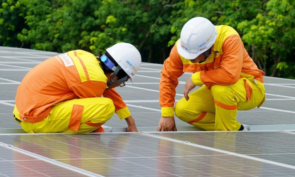 Two men working on photovoltaic panels.