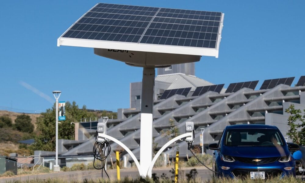 An electric car charges at a transportable, off-grid, solar powered, solar tracking, electric vehicle charger at a National Renewable Energy Laboratory facility.