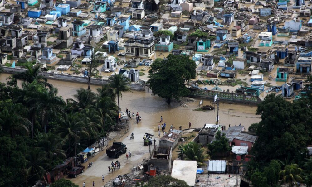Haitian citizens walk through the flooded streets of Port-au-Prince, Haiti, after Hurricane Tomas hit the country.