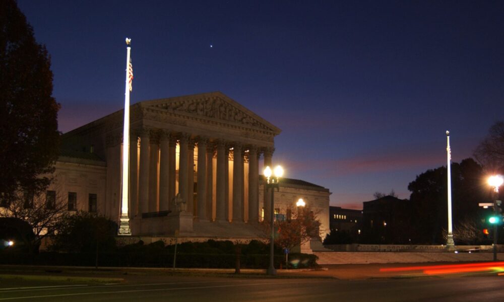 The US Supreme Court building under a twilight sky