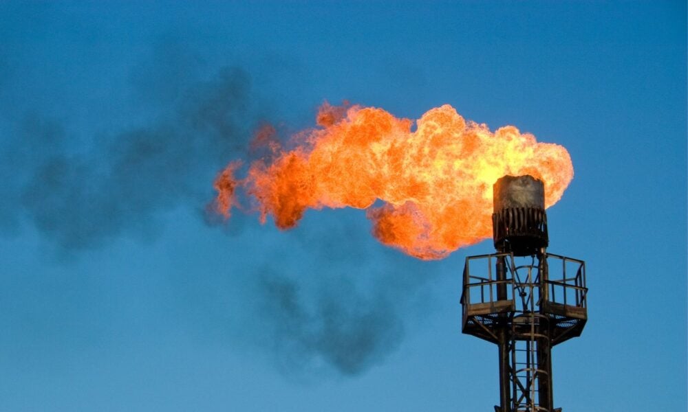 Burning fossil fuel oil flare