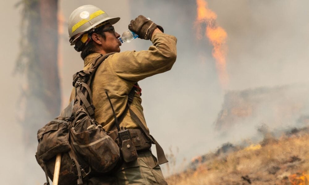 A firefighter drinks water in Oregon during a controlled burn to try to contain wildfires in the state.