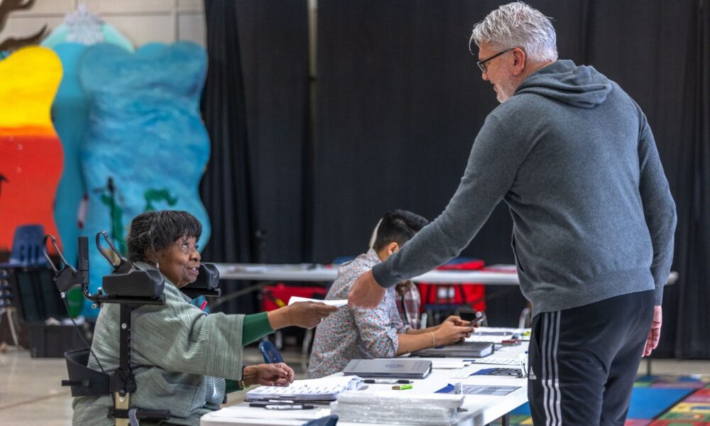 Poll workers assist voters on Super Tuesday at the First Ward Creative Academy, Mecklenburg County Precinct 13 on March 5, 2024 in Charlotte, North Carolina.