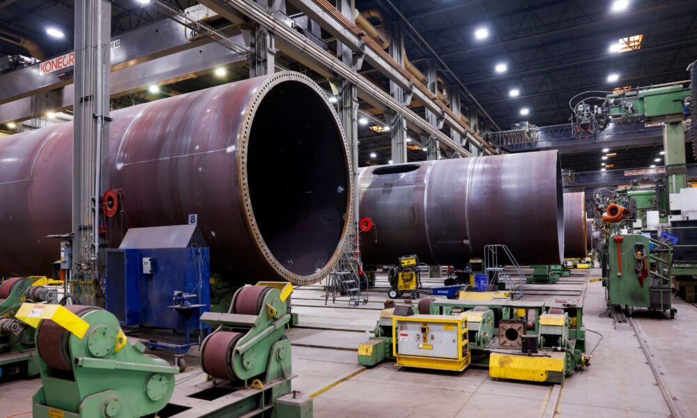 wind turbine towers under construction inside a plant