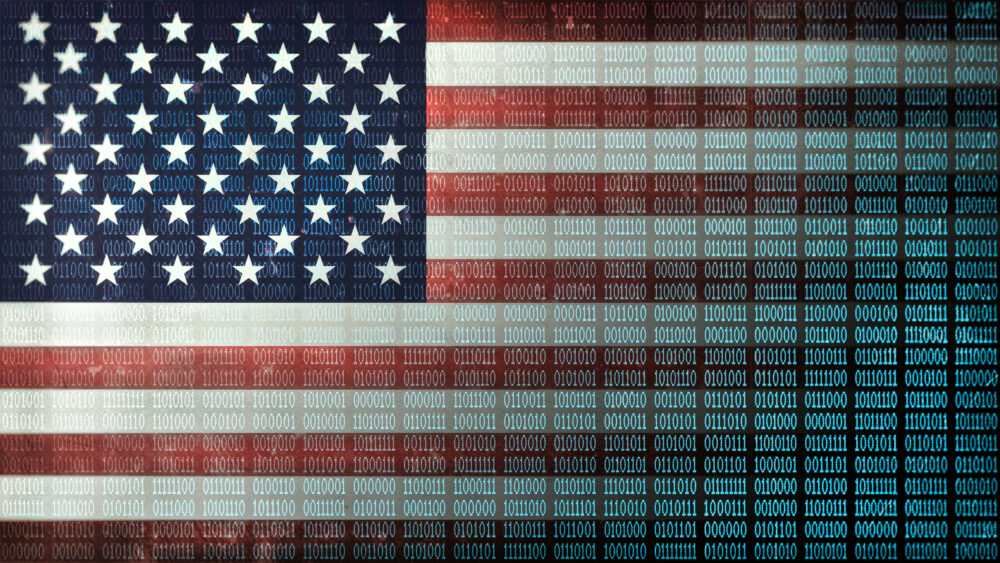 A US flag with binary code superimposed over the image.