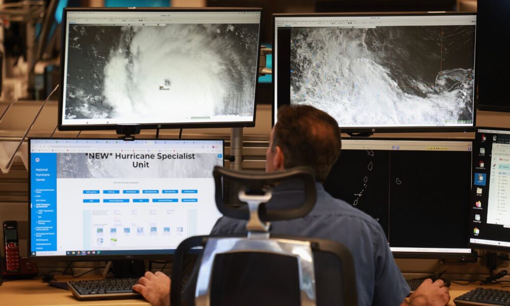 A senior hurricane specialist at the National Hurricane Center works on tracking Hurricane Beryl in 2024.